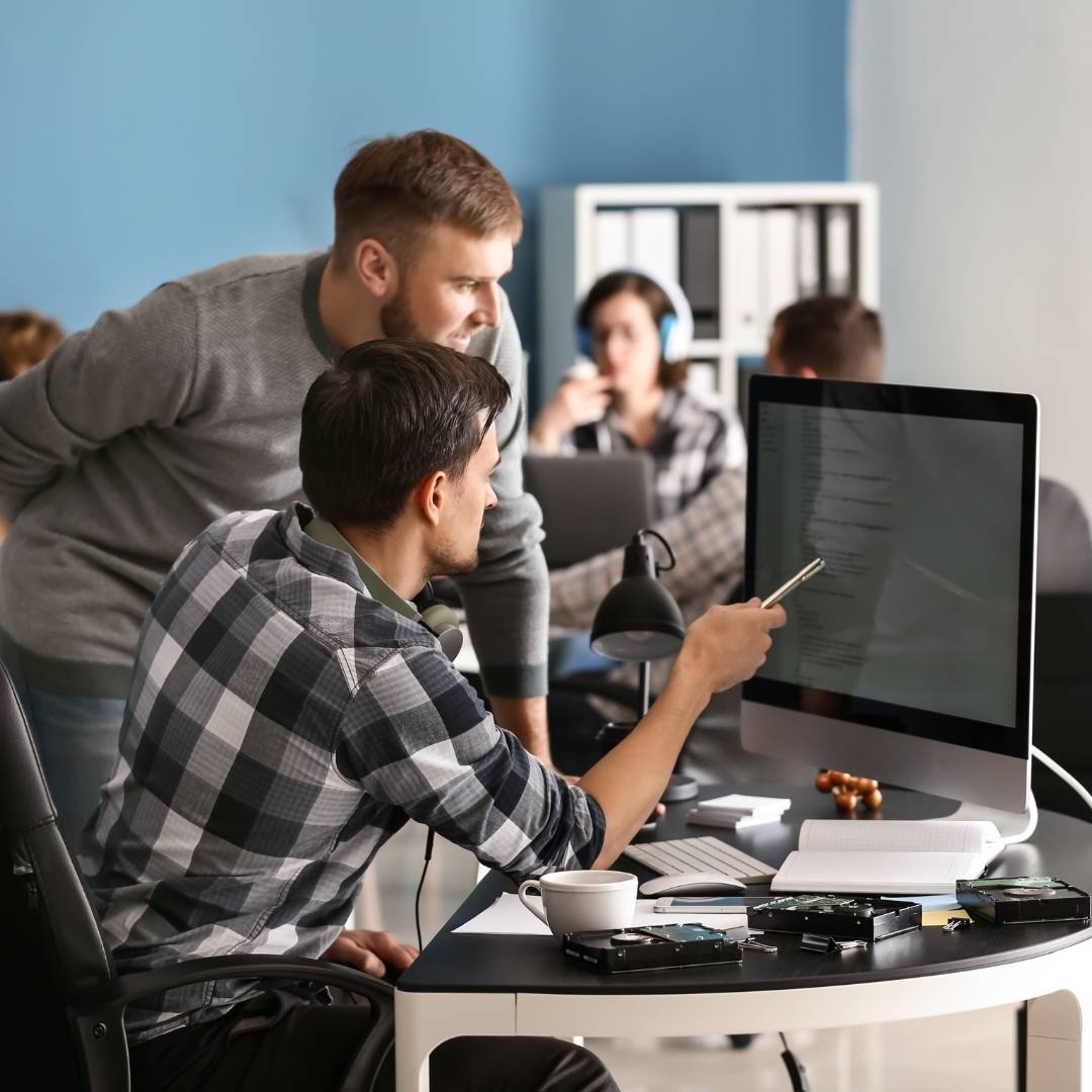 People looking at a computer together