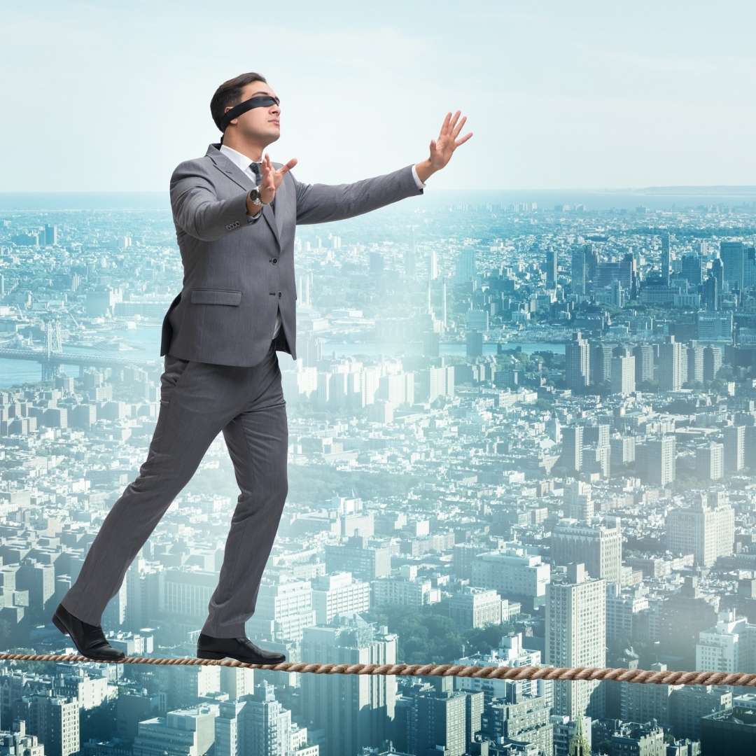 guy in a suit walking a tight rope