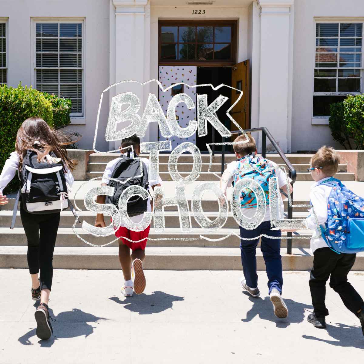 Kids running into a school